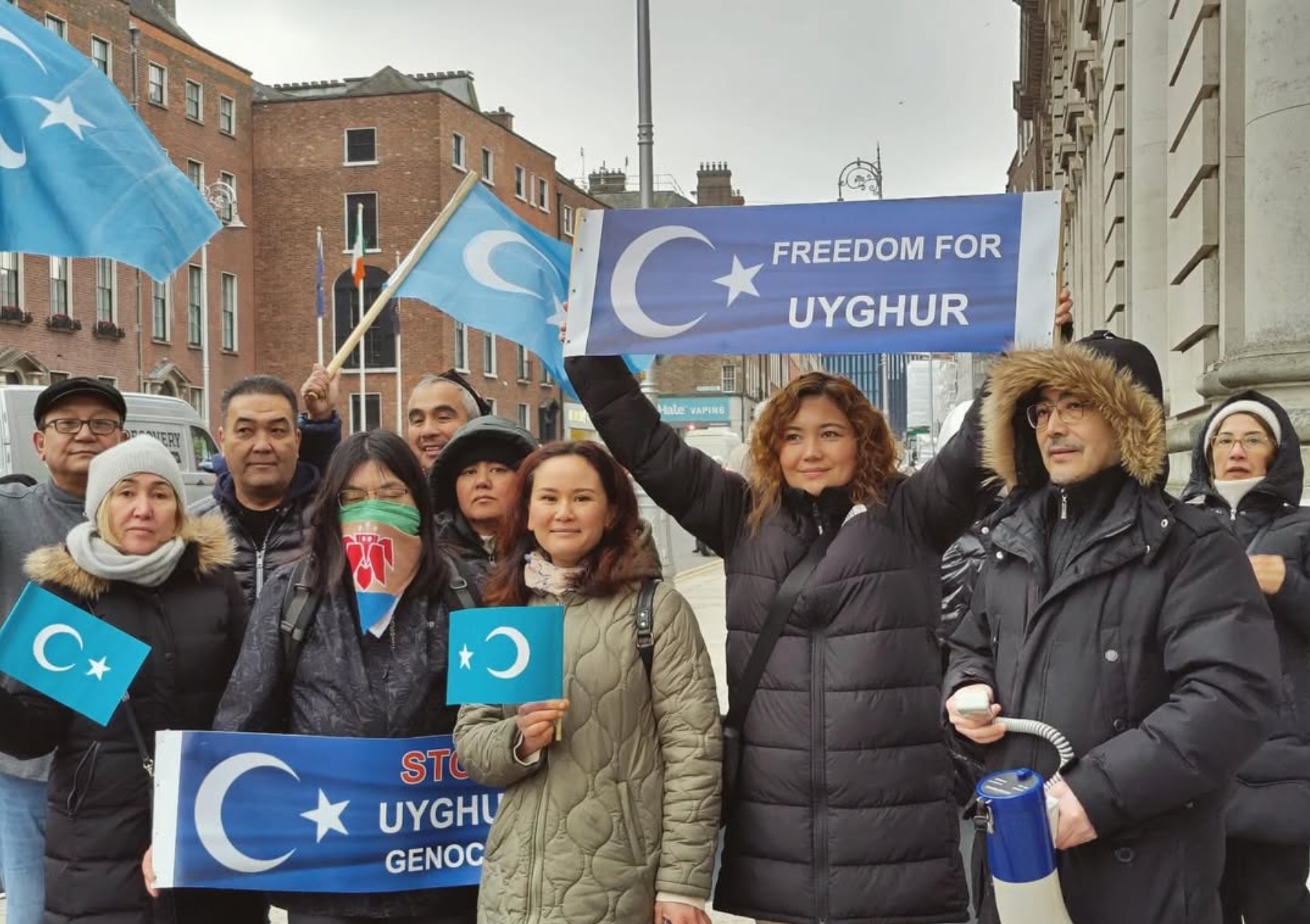 Uyghur protesters in Dublin holding banners reading ' Freedom for Uyghur'